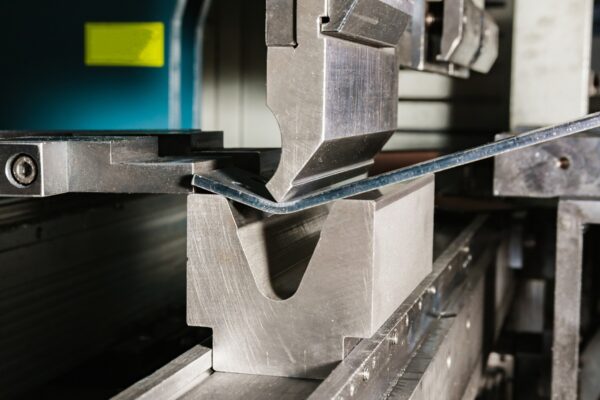 working with sheet metal on CNC hydraulic press brake. Bending sheet metal